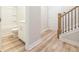 Hallway with the bathroom, a staircase, and light-colored wood floors at 1956 Deco Dr, Kennesaw, GA 30144