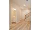 Hallway with bathroom and staircase featuring wood floors and recessed lighting at 1956 Deco Dr, Kennesaw, GA 30144