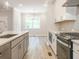 Modern kitchen with white cabinets, stainless steel appliances, and a view into the dining area at 1956 Deco Dr, Kennesaw, GA 30144