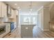 Spacious open-concept kitchen boasts a center island with a sink and stainless appliances at 1956 Deco Dr, Kennesaw, GA 30144