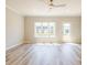 Living room features light floors, a ceiling fan, windows, and a door to patio at 1956 Deco Dr, Kennesaw, GA 30144