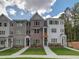 Three story townhome community with inviting front yards at 1996 Deco Dr, Kennesaw, GA 30144