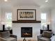 Modern white brick fireplace with wooden mantel, flanked by windows and side tables with stylish lamps at 1996 Deco Dr, Kennesaw, GA 30144