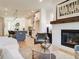Bright open-concept living room featuring a fireplace, hardwood floors, and seamless access to the kitchen at 1996 Deco Dr, Kennesaw, GA 30144