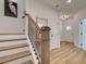 Modern staircase with dark metal balusters and light wood handrail at 1996 Deco Dr, Kennesaw, GA 30144