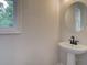 Bathroom featuring a pedestal sink and a window at 1980 Deco Dr, Kennesaw, GA 30144