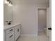 Well-lit bathroom with white cabinets, modern fixtures, and marble-look tile flooring at 1980 Deco Dr, Kennesaw, GA 30144