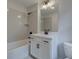 Bathroom featuring shower and tub combination, white subway tile, black hardware, and white vanity at 1980 Deco Dr, Kennesaw, GA 30144