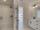 Modern bathroom featuring tiled shower with a bench, vanity with a white countertop, and sleek fixtures at 1980 Deco Dr, Kennesaw, GA 30144