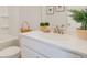 Bright bathroom featuring a toilet, bathtub and a vanity with white countertops at 1980 Deco Dr, Kennesaw, GA 30144