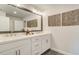 Modern bathroom featuring a large mirror and double sinks with a white countertop at 1980 Deco Dr, Kennesaw, GA 30144
