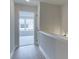 Upstairs hallway with white walls, trim, light wood floors and views of the outside at 1980 Deco Dr, Kennesaw, GA 30144