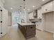 Bright kitchen features white cabinets, stainless steel appliances, a large island with pendant lighting and light wood floors at 1980 Deco Dr, Kennesaw, GA 30144