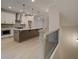 Kitchen featuring a large center island, pendant lights, stainless steel appliances and neutral colored cabinets at 1980 Deco Dr, Kennesaw, GA 30144