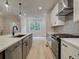 Bright kitchen featuring a stainless steel stove, herringbone backsplash, and an island with a sink at 1980 Deco Dr, Kennesaw, GA 30144