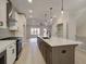Modern kitchen with a large center island, stainless steel appliances, and stylish pendant lighting at 1980 Deco Dr, Kennesaw, GA 30144
