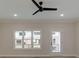 Bright living room with a ceiling fan, large windows, and a door leading to the exterior at 1980 Deco Dr, Kennesaw, GA 30144