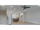 Open concept living area with kitchen island, stainless appliances, and stairs to the second floor at 1980 Deco Dr, Kennesaw, GA 30144