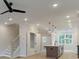 Open concept living room with kitchen island, stairs, pantry and light wood floors at 1980 Deco Dr, Kennesaw, GA 30144