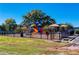 Exterior shot of the playground with safety fencing and tables with sunshades at 1980 Deco Dr, Kennesaw, GA 30144