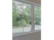 A large window view of a wooded area with a road running through it at 1980 Deco Dr, Kennesaw, GA 30144