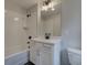 Stylish bathroom featuring a shower-tub, white vanity, and modern fixtures at 1988 Deco Dr, Kennesaw, GA 30144