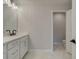 Elegant bathroom with a white double vanity, quartz countertop, and marble tile at 1988 Deco Dr, Kennesaw, GA 30144