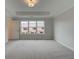 Spacious bedroom with a tray ceiling, carpeted floor and a large window at 1988 Deco Dr, Kennesaw, GA 30144