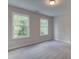 Neutral bedroom with two large windows providing ample natural light and plush carpet at 1988 Deco Dr, Kennesaw, GA 30144
