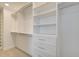 Spacious walk-in closet with custom shelving, drawers, and ample storage space at 1988 Deco Dr, Kennesaw, GA 30144