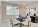 Bright dining room features modern chandelier, neutral colors and lots of natural light at 1988 Deco Dr, Kennesaw, GA 30144