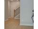 Bright entryway with wood floors, a staircase with metal railing, and a view of the front door at 1988 Deco Dr, Kennesaw, GA 30144