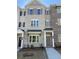 Close up of a lovely home exterior with gray brick and siding, with well-maintained landscaping and an inviting doorway at 1988 Deco Dr, Kennesaw, GA 30144