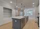 Kitchen features an island, stainless appliances, ample storage and easy access to other living areas at 1988 Deco Dr, Kennesaw, GA 30144