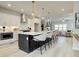 Modern kitchen with white cabinets, stainless steel appliances and an island with barstool seating at 1988 Deco Dr, Kennesaw, GA 30144