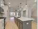 Gorgeous kitchen boasts an island, stainless appliances, white cabinets, and open access to the Gathering room at 1988 Deco Dr, Kennesaw, GA 30144