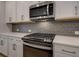 Close up image of stainless appliances, modern backsplash, and quartz countertops in the kitchen at 1988 Deco Dr, Kennesaw, GA 30144