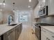 This kitchen showcases stainless appliances, a large island, and open access to other rooms at 1988 Deco Dr, Kennesaw, GA 30144