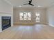 Spacious living room features a modern fireplace, a ceiling fan, and plenty of natural light at 1988 Deco Dr, Kennesaw, GA 30144