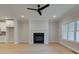 Bright, spacious living room with modern fireplace, access to other rooms, and bright sunlight at 1988 Deco Dr, Kennesaw, GA 30144