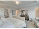 Tranquil main bedroom with a walk-in closet, neutral tones, tray ceiling, and comfortable seating area at 1988 Deco Dr, Kennesaw, GA 30144
