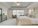 Serene main bedroom with a large window, a tray ceiling, and a comfortable seating area at 1988 Deco Dr, Kennesaw, GA 30144