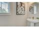 Chic powder room with pedestal sink, modern fixtures, and decorative accents create an inviting space at 1988 Deco Dr, Kennesaw, GA 30144