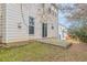 Backyard view of the home with a small concrete patio and grassy area at 1623 Bradmere Ln, Lithia Springs, GA 30122