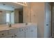 Bathroom featuring double sinks, a large mirror, and white cabinets at 1623 Bradmere Ln, Lithia Springs, GA 30122