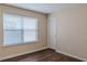 This bedroom features vinyl floors, a window, and tan walls at 1623 Bradmere Ln, Lithia Springs, GA 30122