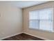 Bright bedroom with dark wood floors and a large window with blinds at 1623 Bradmere Ln, Lithia Springs, GA 30122