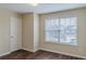 This bedroom features a window, door, and vinyl floors at 1623 Bradmere Ln, Lithia Springs, GA 30122