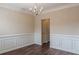 Elegant dining room with wainscoting detail, chandelier lighting, and hardwood flooring at 1623 Bradmere Ln, Lithia Springs, GA 30122