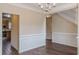 Spacious dining room featuring stylish wainscoting, hardwood floors, and abundant natural light at 1623 Bradmere Ln, Lithia Springs, GA 30122